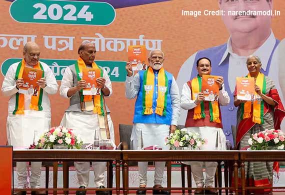 PM Modi presents Copy of BJP's Manifesto to Neelavati Maurya in Delhi